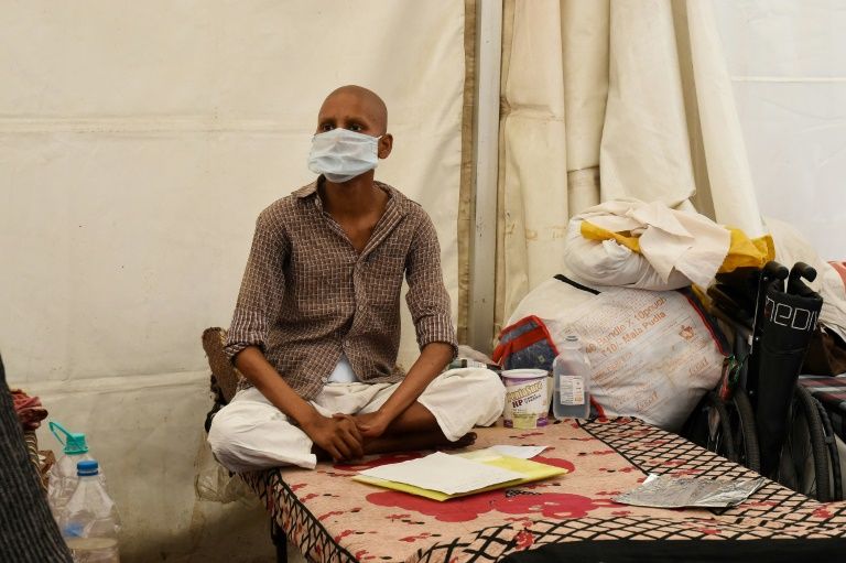 Cancer patient Mohammed Shan-e-Alam said: 'Now I can't go home and I can't go to the hospital.' (AFP Photo/Prakash SINGH)