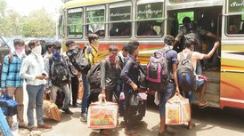 Migrants from Ahmedabad board a bus for South 24 Parganas, during the ongoing COVID-19 nationwide lockdown, in Calcutta on Wednesday, May 27, 2020. 