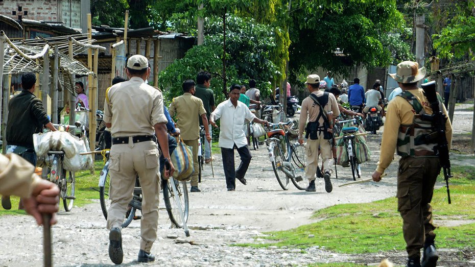 Police force villagers to go back to their homes as they were going to a market during ongoing Covid-19 lockdown, at Bagan Para in Baksa district of Assam on Sunday.