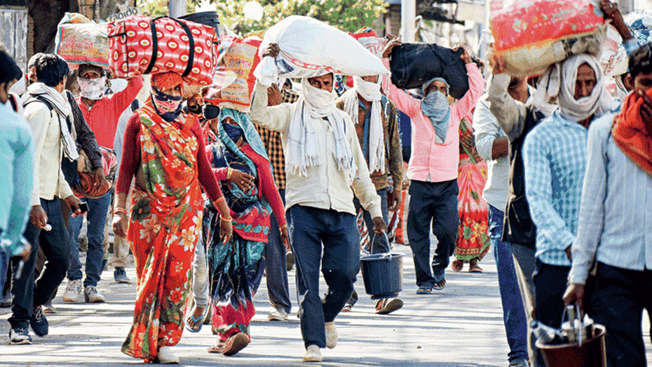 Migrants walk towards their native places amid the lockdown in Allahabad on Saturday.