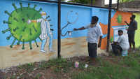 Covid-19: Artists give final touches to wall paintings of corona warriors in Vizag 